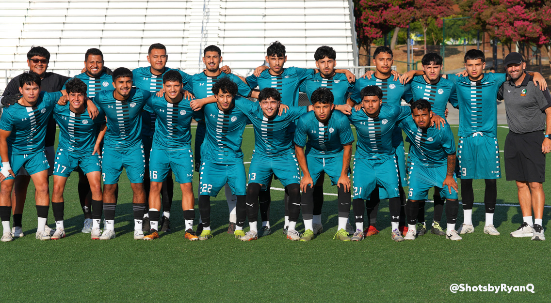 men's soccer players in blue in a team photo